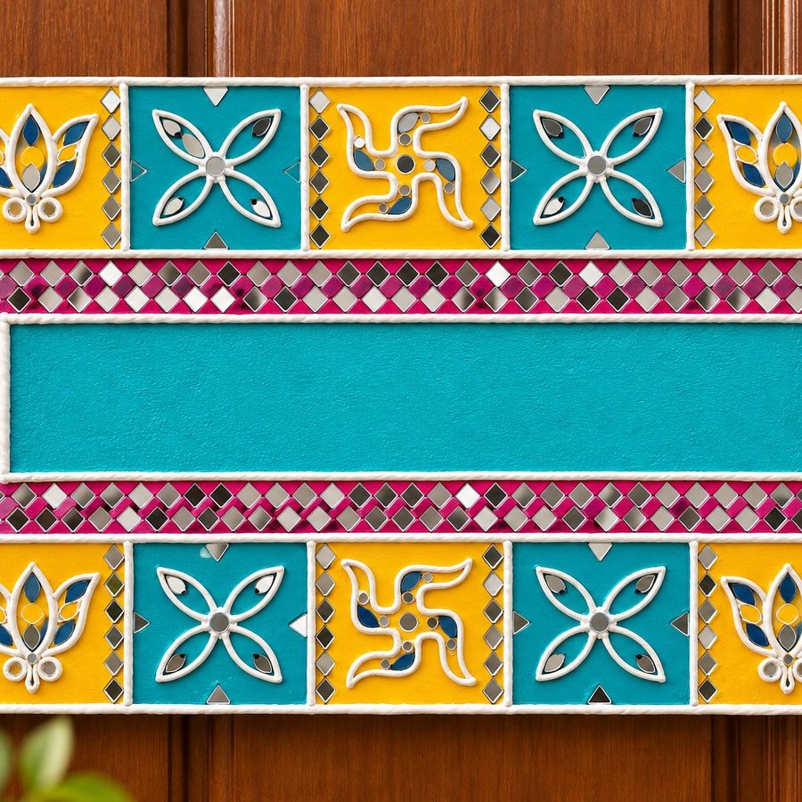 Yellow and teal rectangular name plate with lotus tiles, swastik motifs and mirror work
